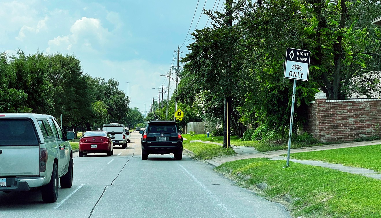 A car drives in the designated bike lane along Antoine Drive in northwest Houston.
