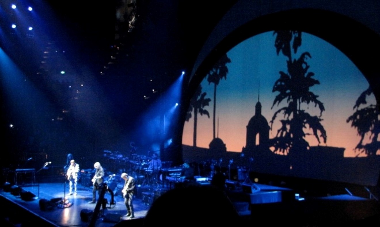 The Eagles, seen here with the Hotel California looming behind them, will be at Toyota Center Saturday night.