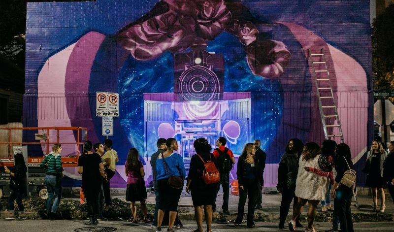 Fresh Arts Mural Tour in 2019, showing off the mural by Alex Arzu at 1800 Washington Ave.