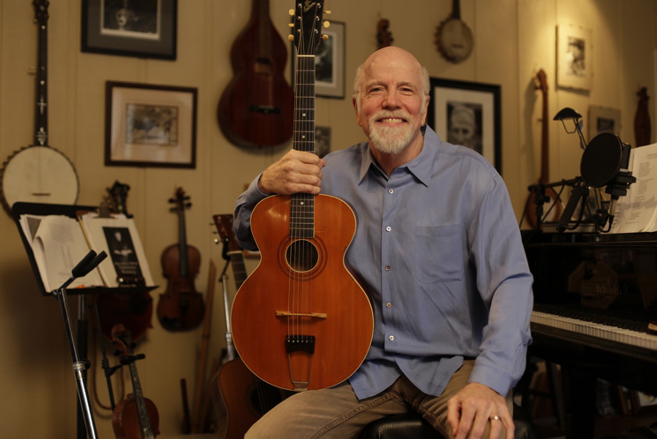 John McCutcheon in the music room at his home.