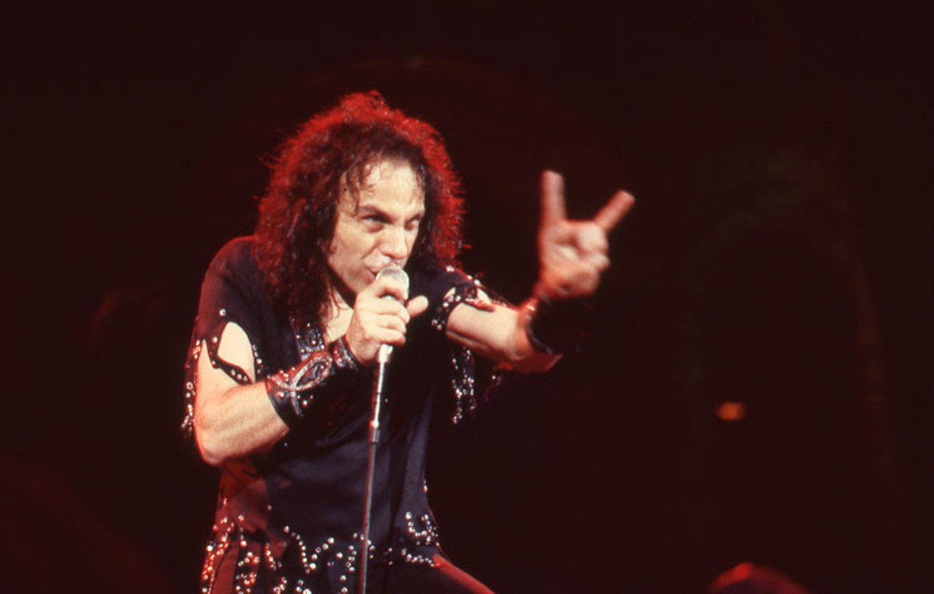 Ronnie James Dio throws the now ubiquitous "maloik" in concert.