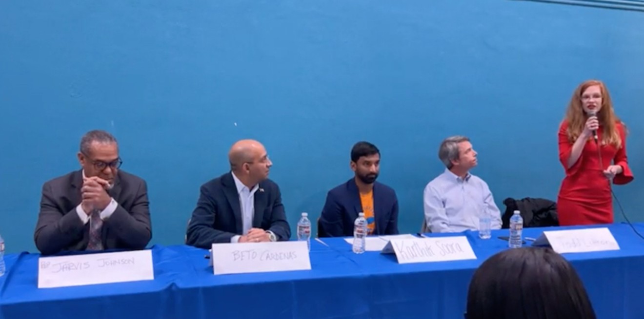 Molly Cook (standing) at a January Senate District candidate forum with Texas. Rep Jarvis Johnson. (far left).