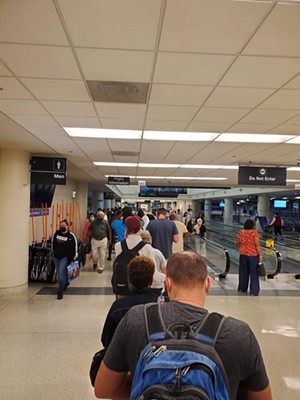 A queue of furious travelers formed outside the gate. - PHOTO BY MEGHAN DAVENPORT