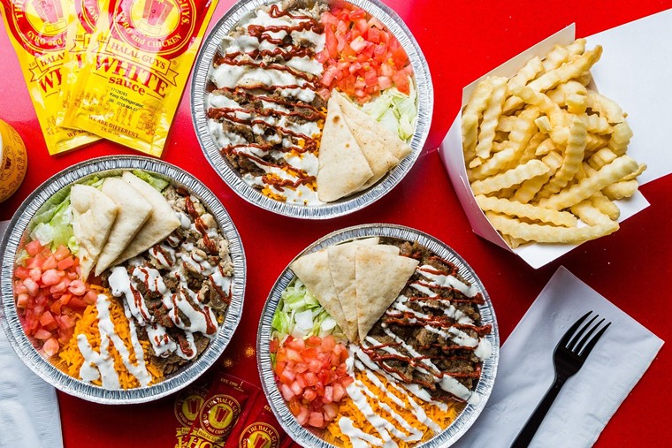 Combo platters can be topped with white or hot sauce, or both. - PHOTO BY THE HALAL GUYS