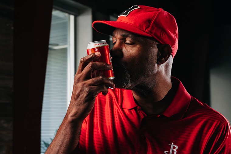 Clutch City Lager gets a smooch from the Kiss of Death himself, Mario Elie. - PHOTO BY KARBACH BREWING CO.