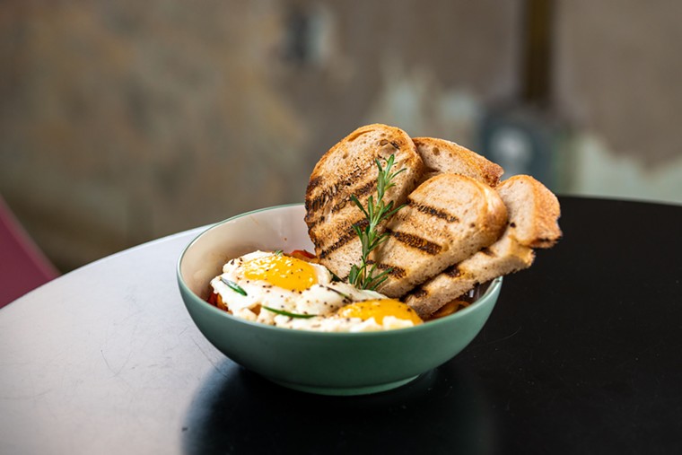 The Tomato Bowl is served with sunnyside up eggs and sourdough toast points. - PHOTO BY DYLAN MCEWAN