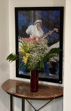 ZZ Top bassist Dusty Hill displays his rock and roll bona fides while lurking behind some fresh flowers. - PHOTO BY TOM RICHARDS