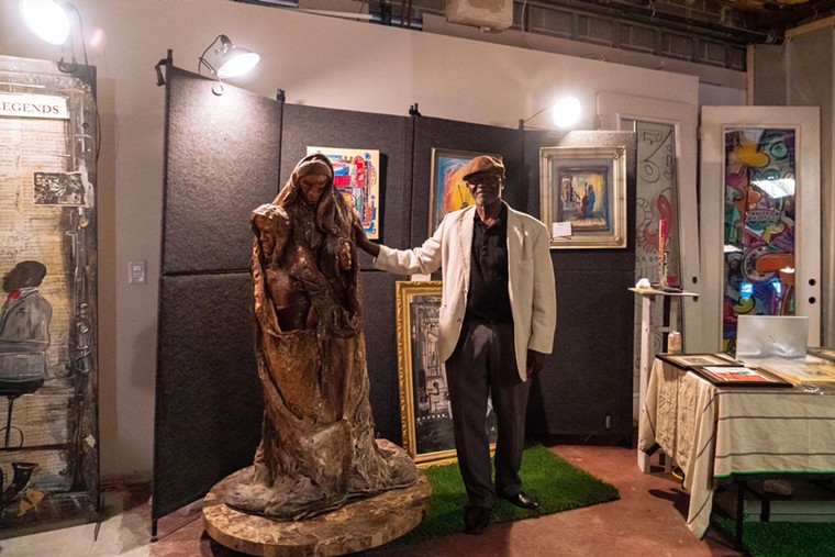 Charles Washington stands with some of his art pieces.  - PHOTO BY DYLAN MCEWAN