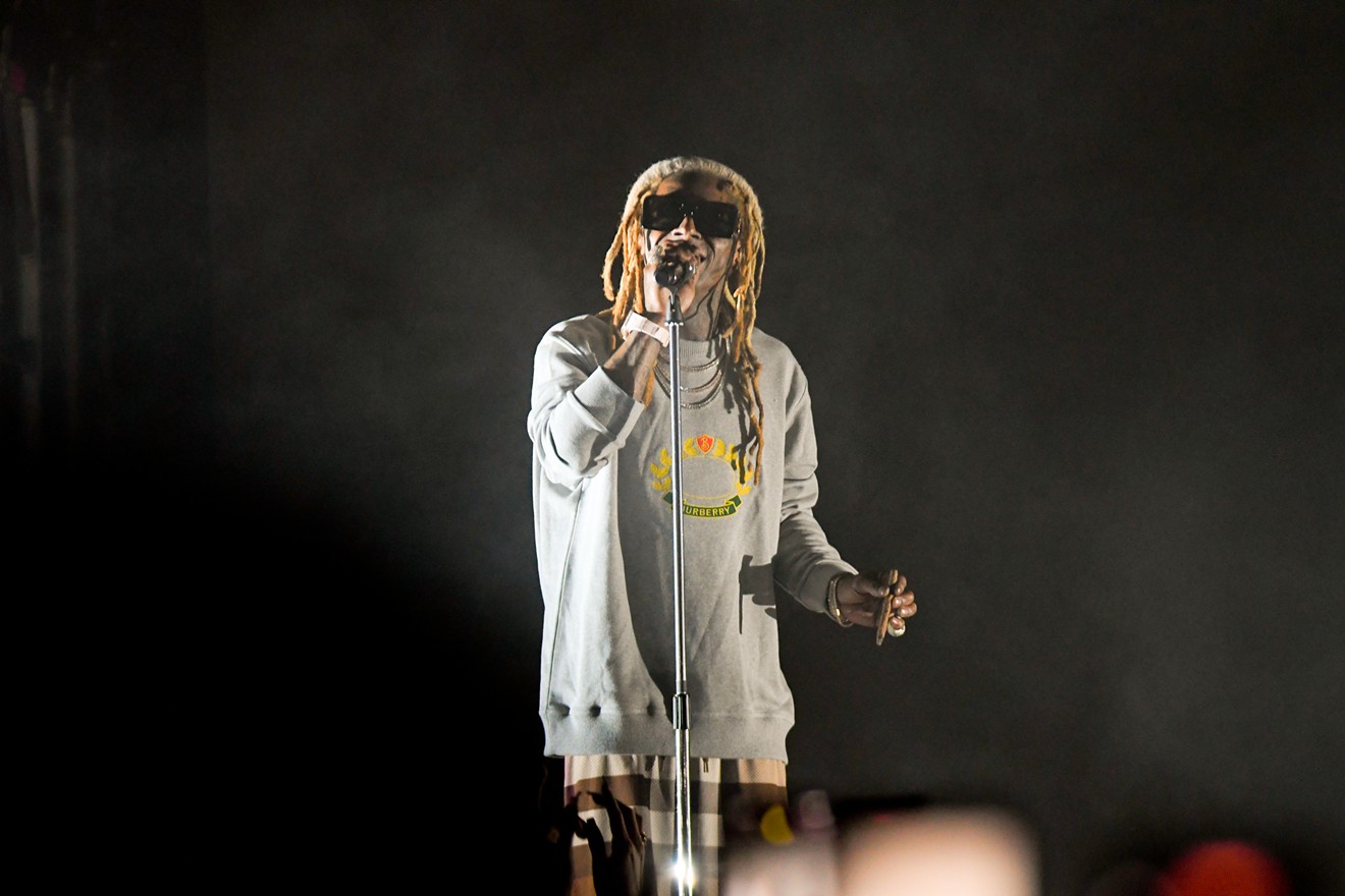 Lil Wayne stands before a sold out room of screaming fans.